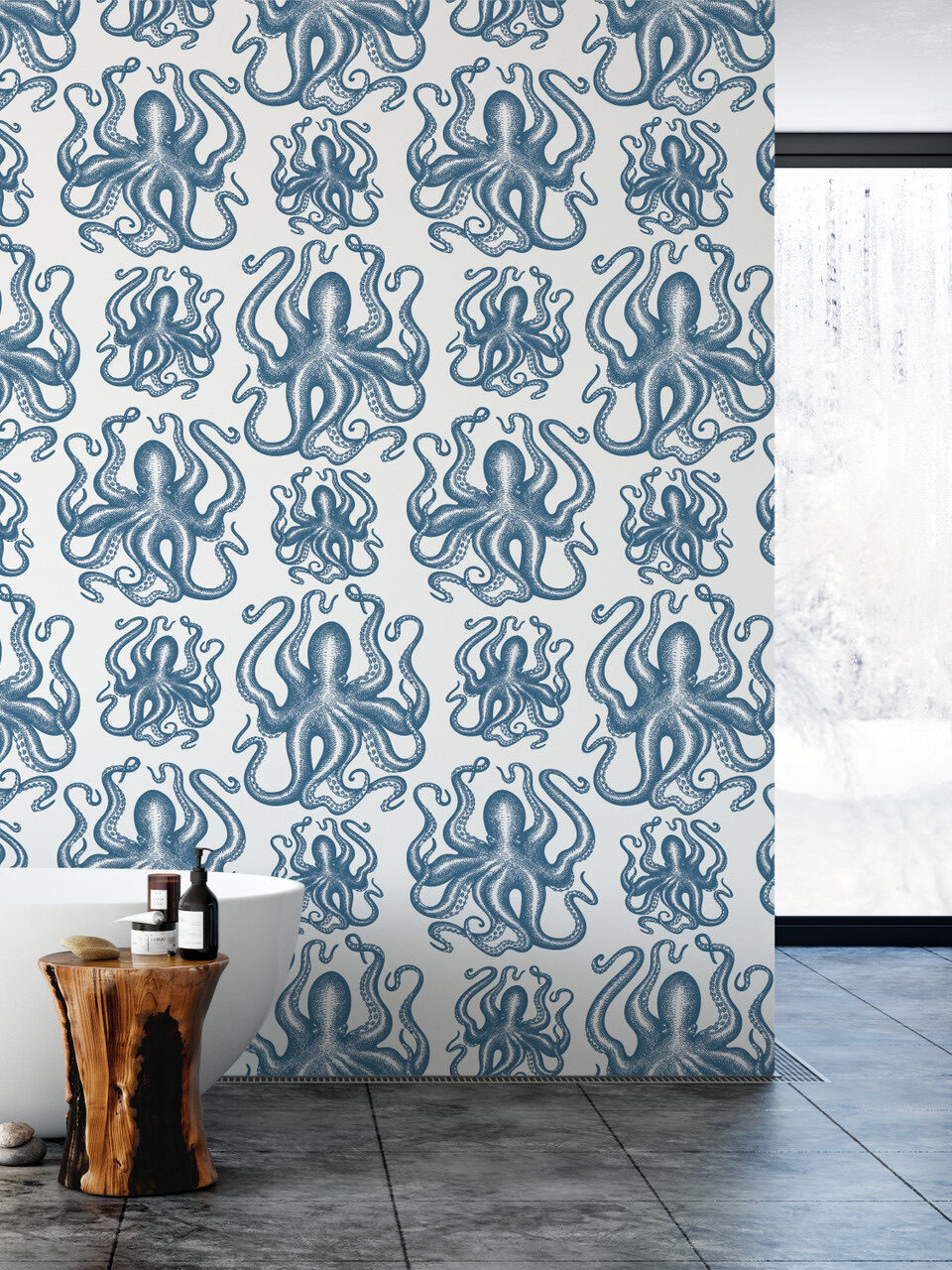 Modern bathroom with octopus patterned wallpaper, freestanding tub, wooden stool, and a basket. natural light streams in from a window.